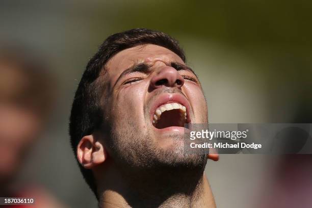 Jimmy Toumpas reacts after a hard run during a Melbourne Demons AFL training session at Gosch's Paddock on November 6, 2013 in Melbourne, Australia.