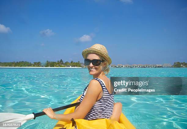 paddling towards the beach - kayaker woman stock pictures, royalty-free photos & images