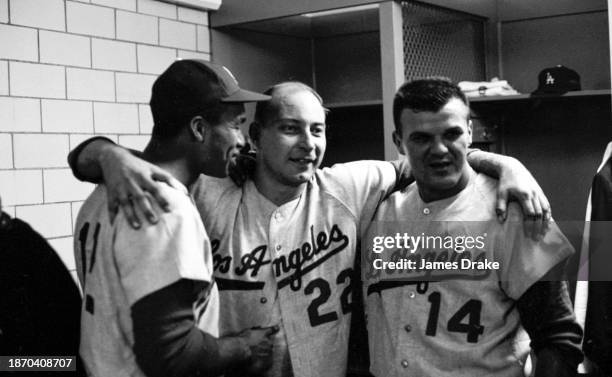 Tommy Davis, Johnny Podres and Bill Skowron of the Los Angeles Dodgers celebrate the team's 4-1 win over the New York Yankees in Game Two of the...