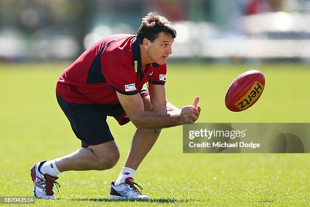 Coach Paul Roos handpasses a ball during a Melbourne Demons AFL training session at Gosch's Paddock on November 6, 2013 in Melbourne, Australia.