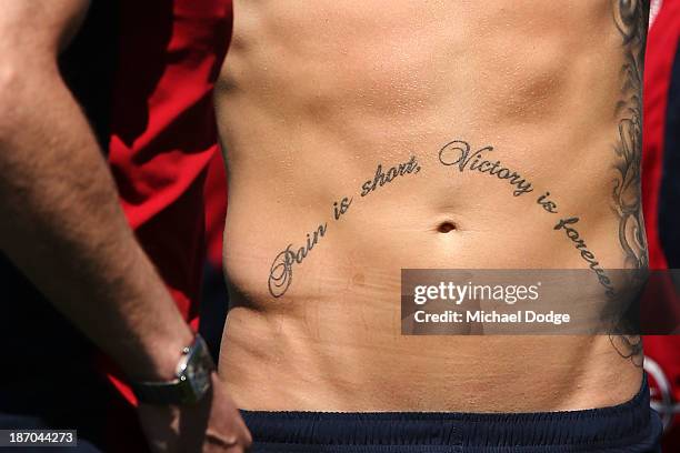 Tattoo is seen on the stomach of Jeremy Howe during a Melbourne Demons AFL training session at Gosch's Paddock on November 6, 2013 in Melbourne,...