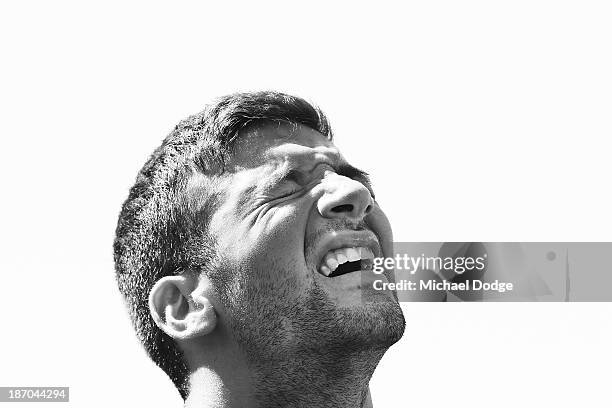 Jimmy Toumpas reacts after a hard run during a Melbourne Demons AFL training session at Gosch's Paddock on November 6, 2013 in Melbourne, Australia.