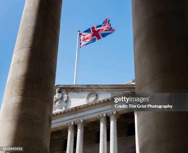 union jack flag flying above a building in the city of london - bank of england stock pictures, royalty-free photos & images