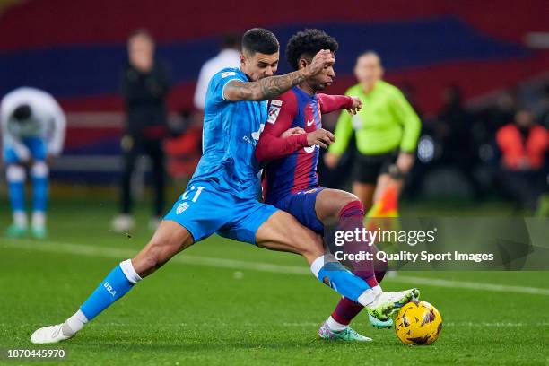 Alejandro Balde of FC Barcelona competes for the ball with Juan Brandariz 'Chumi' of UD Almeria during the LaLiga EA Sports match between FC...