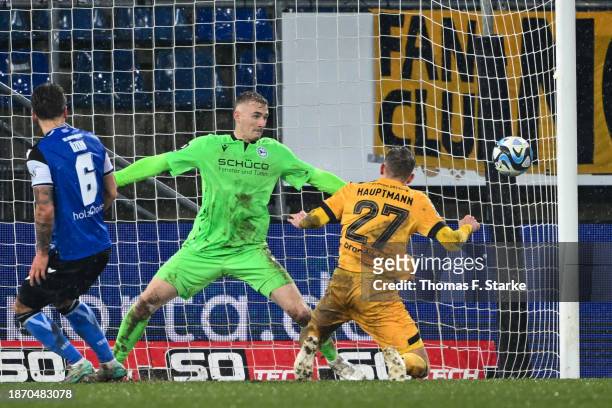 Niklas Hauptmann of Dresden heads his teams first goal against Jonas Kersken of Bielefeld during the 3. Liga match between Arminia Bielefeld and...