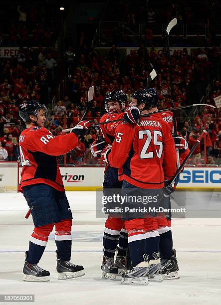 The Washington Capitals celebrate after Alexander Urbom scored a goal in the second period of an NHL game against the New York Islanders at Verizon...