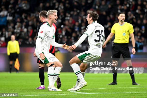 Max Woeber of Borussia Moenchengladbach celebrates with teammate Julian Weigl after scoring their team's first goal during the Bundesliga match...