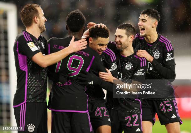 Jamal Musiala of Bayern Munich celebrates with teammates after scoring their team's first goal during the Bundesliga match between VfL Wolfsburg and...