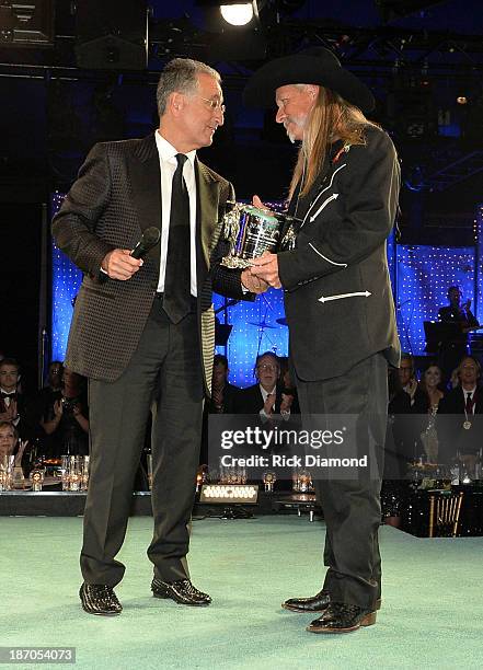 President Del Bryant presents BMI Icon Award to songwriter Dean Dillon onstage during the 61st annual BMI Country Awards on November 5, 2013 in...