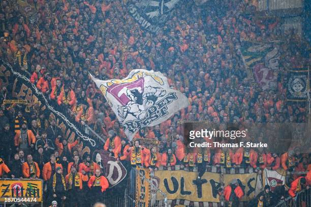 Supporters of Dresden celebrate during the 3. Liga match between Arminia Bielefeld and Dynamo Dresden at Schueco Arena on December 20, 2023 in...