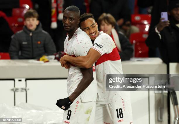 Sehrou Guirassy of VfB Stuttgart celebrates with teammate Jamie Leweling after scoring their team's second goal during the Bundesliga match between...