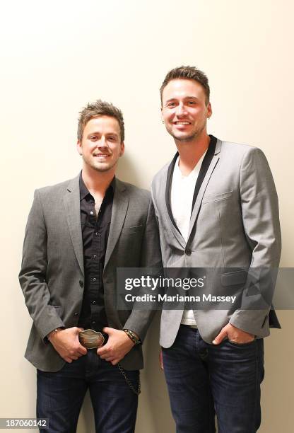 Stephen Barker Liles and Eric Gunderson of Love & Theft pose for a portrait before they perform during the 2013 CMA Songwriters Series at the CMA...