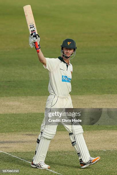 Jordan Silk of the Tigers celebrates his century during day one of the Sheffield Shield match between the Queensland Bulls and the Tasmania Tigers at...