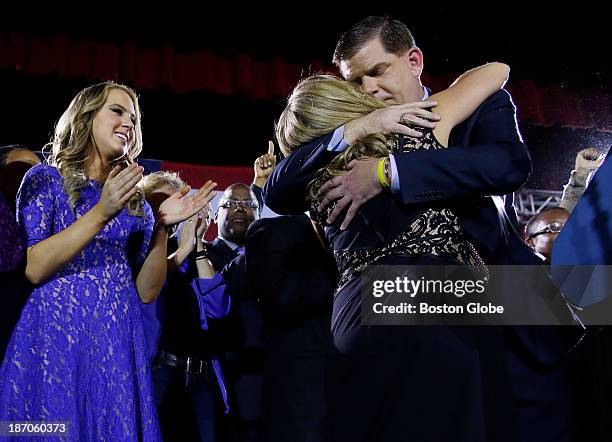 Marty Walsh hugs his longtime partner Lorrie Higgins as her daughter, Lauren, left, looks on, at his Election Night party at the Park Plaza hotel in...