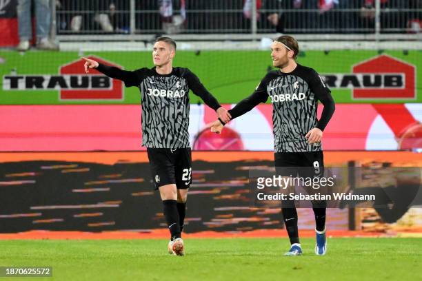 Lucas Hoeler of Sport-Club Freiburg celebrates with teammate Roland Sallai after scoring their team's second goal during the Bundesliga match between...