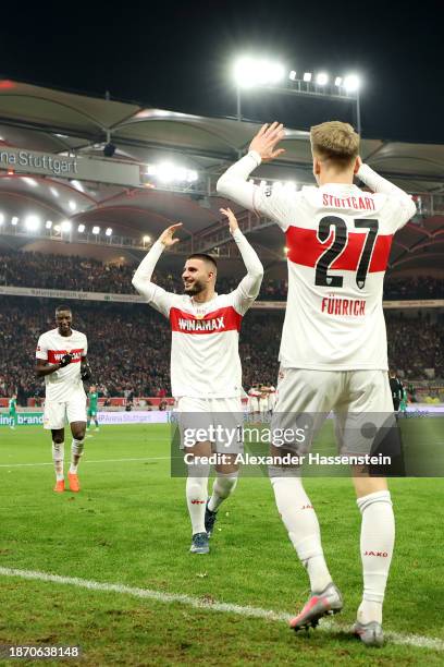 Chris Fuehrich of VfB Stuttgart celebrates with teammate Deniz Undav after scoring their team's third goal during the Bundesliga match between VfB...