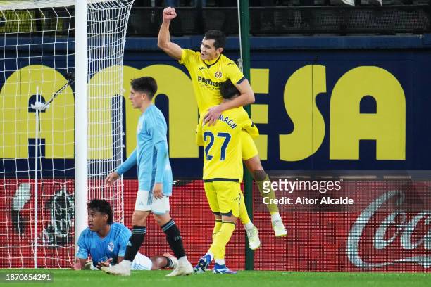 Aissa Mandi of Villarreal CF celebrates with teammate Ilias Akhomach after scoring their team's second goal during the LaLiga EA Sports match between...