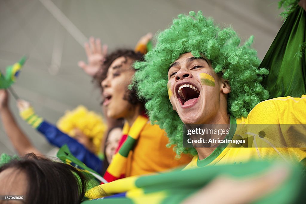 Ecstatic Brazilian fan watching a Football game