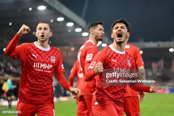 Kevin Sessa and Jonas Foehrenbach of 1.FC Heidenheim celebrate after their team mate Tim Kleindienst scores their team's second goal during the...