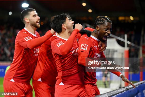 Omar Traore of 1.FC Heidenheim celebrates with teammates after their team's third goal, an own goal by Matthias Ginter of Sport-Club Freiburg during...