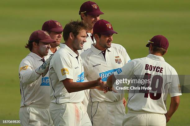 Ryan Harris of the Bulls celebrates with team mates after dismissing Jordan Silk of the Tigers during day one of the Sheffield Shield match between...