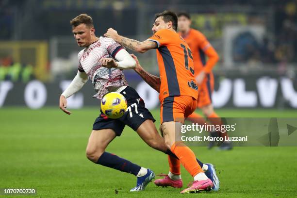 Sydney van Hooijdonk of Bologna FC and Francesco Acerbi of FC Internazionale battle for the ball during the Coppa Italia Round of 16 match between FC...