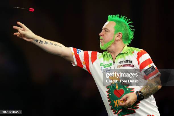 Peter Wright throws during the round 2 match against Jim Williams on day 6 of the 2023/24 Paddy Power World Darts Championship at Alexandra Palace on...