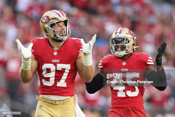 Defensive end Nick Bosa and linebacker Demetrius Flannigan-Fowles of the San Francisco 49ers react during the NFL game at State Farm Stadium on...