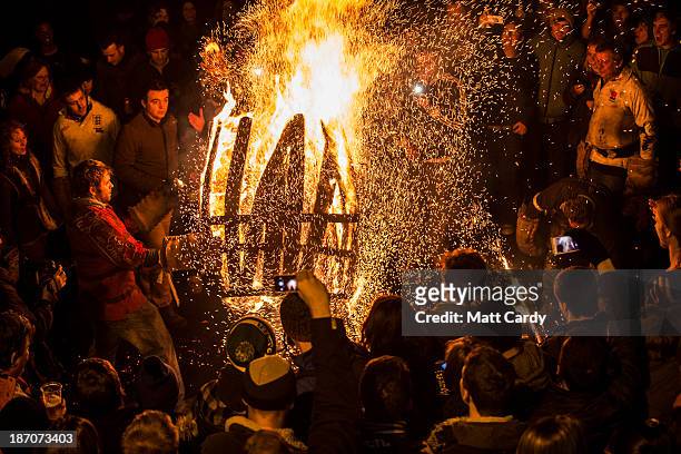 Burning barrel soaked in tar is carried ablaze through the crowds at the annual Ottery St Mary Tar Barrel festival on November 5 2013 in Ottery St...