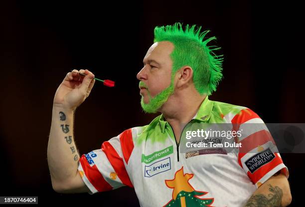 Peter Wright throws during the round 2 match against Jim Williams on day 6 of the 2023/24 Paddy Power World Darts Championship at Alexandra Palace on...