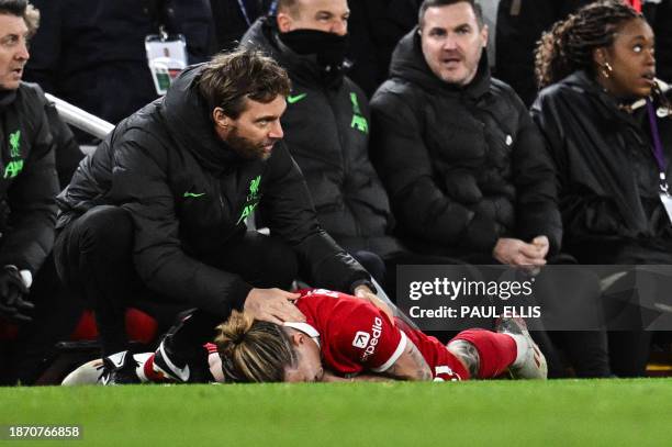 Liverpool's Greek defender Kostas Tsimikas injured following a collision reacts as he lays on the pitch during the English Premier League football...