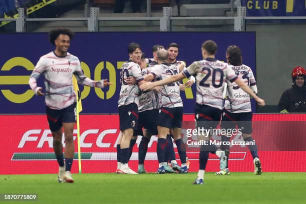 Sam Beukema of Bologna FC celebrates with teammates after scoring their team's first goal during the Coppa Italia Round of 16 match between FC...