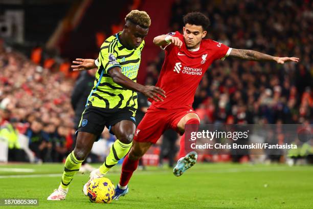 Luis Diaz of Liverpool competes with Bukayo Saka of Arsenal during the Premier League match between Liverpool FC and Arsenal FC at Anfield on...