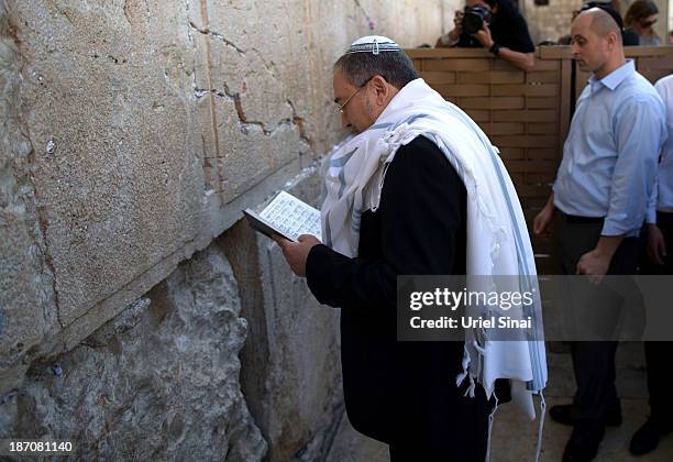 Former Israeli Foreign Minister Avigdor Lieberman prays at the Western wall after the verdict on charges of fraud and breach of trust was given on...