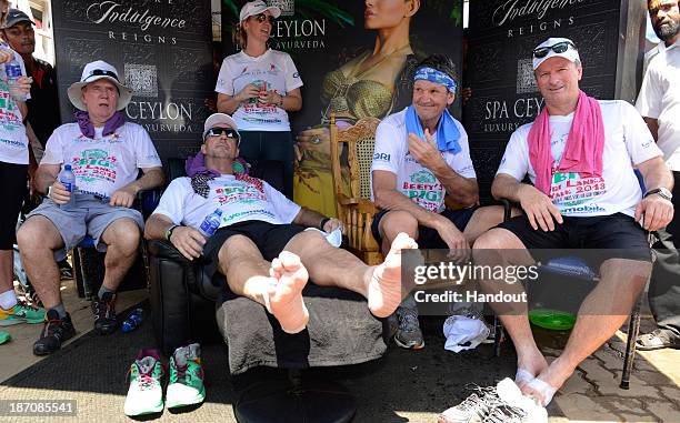 In this handout image provided by Laureus, Sir Ian Botham relaxes with Allan Border, Morne du Plessis and Steve Waugh after completing the sixth day...