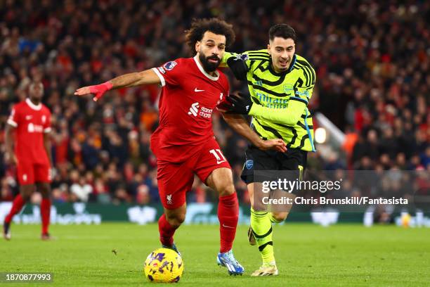 Mohamed Salah of Liverpool competes with Gabriel Martinelli of Arsenal during the Premier League match between Liverpool FC and Arsenal FC at Anfield...