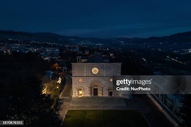 Basilica di Santa Maria di Collemaggio church is seen at blue hour in an aerial view in L'Aquila, Italy, on December 19th, 2023. Basilica di Santa...