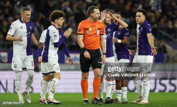 Referee Nathan Verboomen gestures during a soccer match between RSC Anderlecht and KRC Genk, on day 19 of the 2023-2024 'Jupiler Pro League' first...