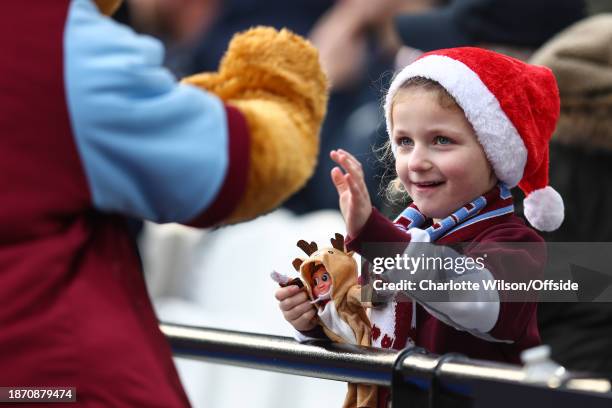 Young West Ham fan with a Christmas hat and an Elf on the Shelf during the Premier League match between West Ham United and Manchester United at...