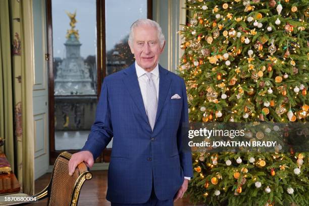 Britain's King Charles III poses during the recording of his Christmas message at Buckingham Palace, London, on December 7, 2023.