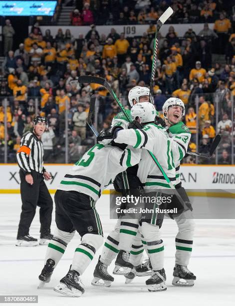 Jani Hakanpaa celebrates his game winning goal with Esa Lindell and Craig Smith of the Dallas Stars against the Nashville Predators during an NHL...