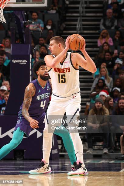 Nikola Jokic of the Denver Nuggets handles the ball during the game against the Charlotte Hornets on December 23, 2023 at Spectrum Center in...