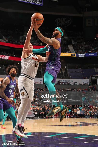 Miles Bridges of the Charlotte Hornets shoots the ball during the game against the Denver Nuggets on December 23, 2023 at Spectrum Center in...