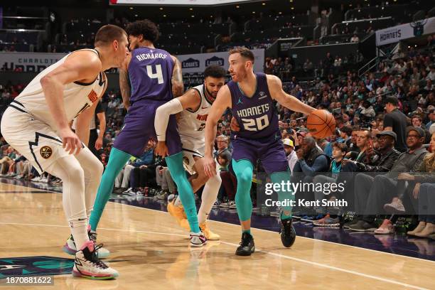 Gordon Hayward of the Charlotte Hornets dribbles the ball during the game against the Denver Nuggets on December 23, 2023 at Spectrum Center in...