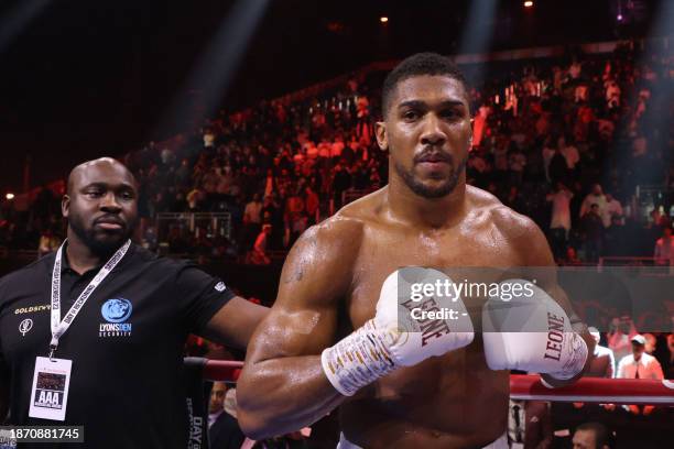Britain's Anthony Joshua celebrates after defeating Sweden's Otto Wallin during their heavyweight boxing match at the Kingdom Arena in Riyadh on...