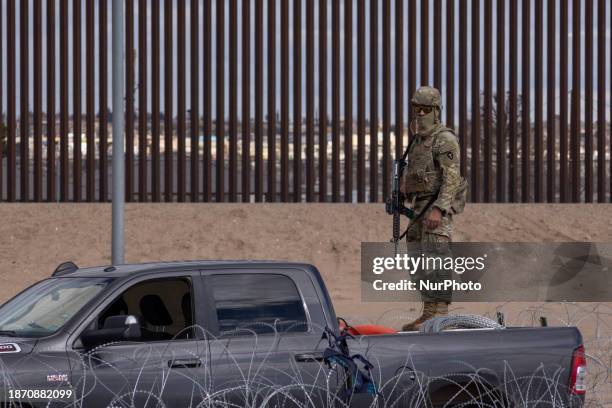 Member of the Texas National Guard is watching over the border between Mexico and the United States, aiming to prevent migrants from crossing.