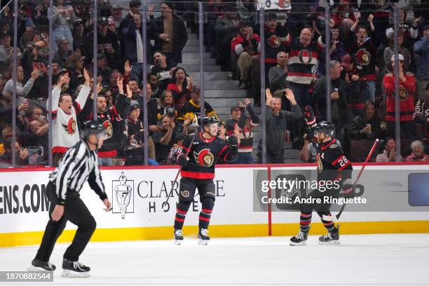 Erik Brannstrom of the Ottawa Senators celebrates his second-period goal against the Pittsburgh Penguins with teammate Claude Giroux at Canadian Tire...