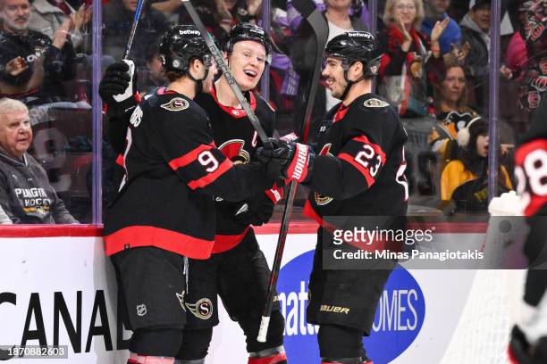 Brady Tkachuk of the Ottawa Senators celebrates his goal with teammates Josh Norris and Travis Hamonic during the second period against the...