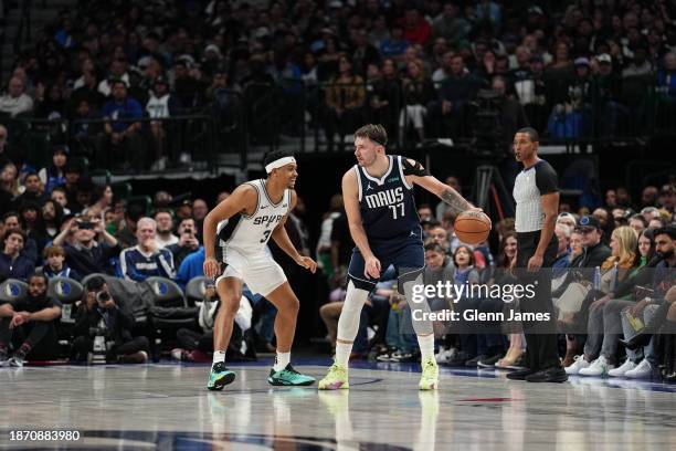 Luka Doncic of the Dallas Mavericks handles the ball against defender Keldon Johnson of the San Antonio Spurs during the game on December 23, 2023 at...