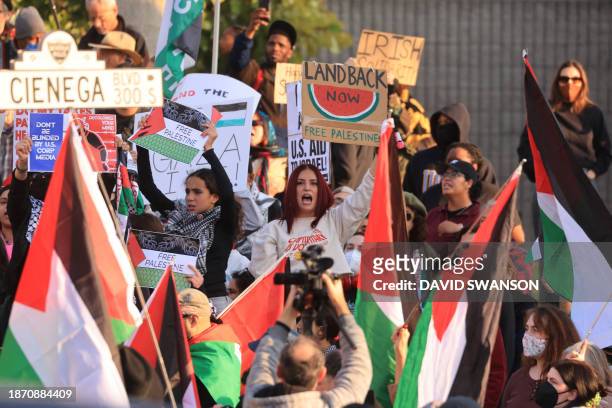Protesters rally during the "Black & Palestinian Solidarity for a Ceasefire this Xmas" by the Beverly Center shopping center in Los Angeles on...